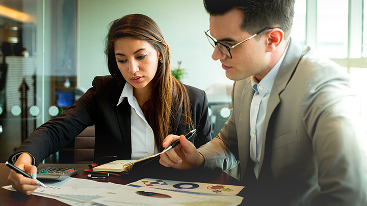 Two businesspeople working on a project together
