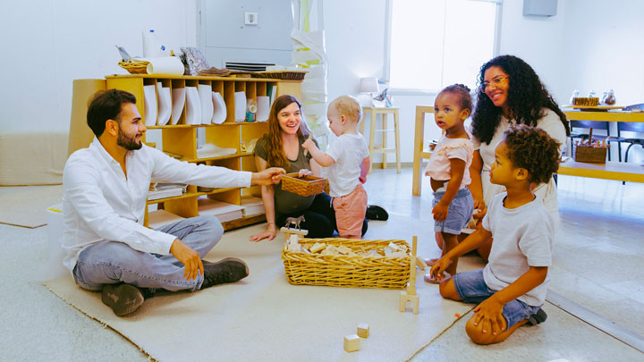 A group of people working with a group of students.